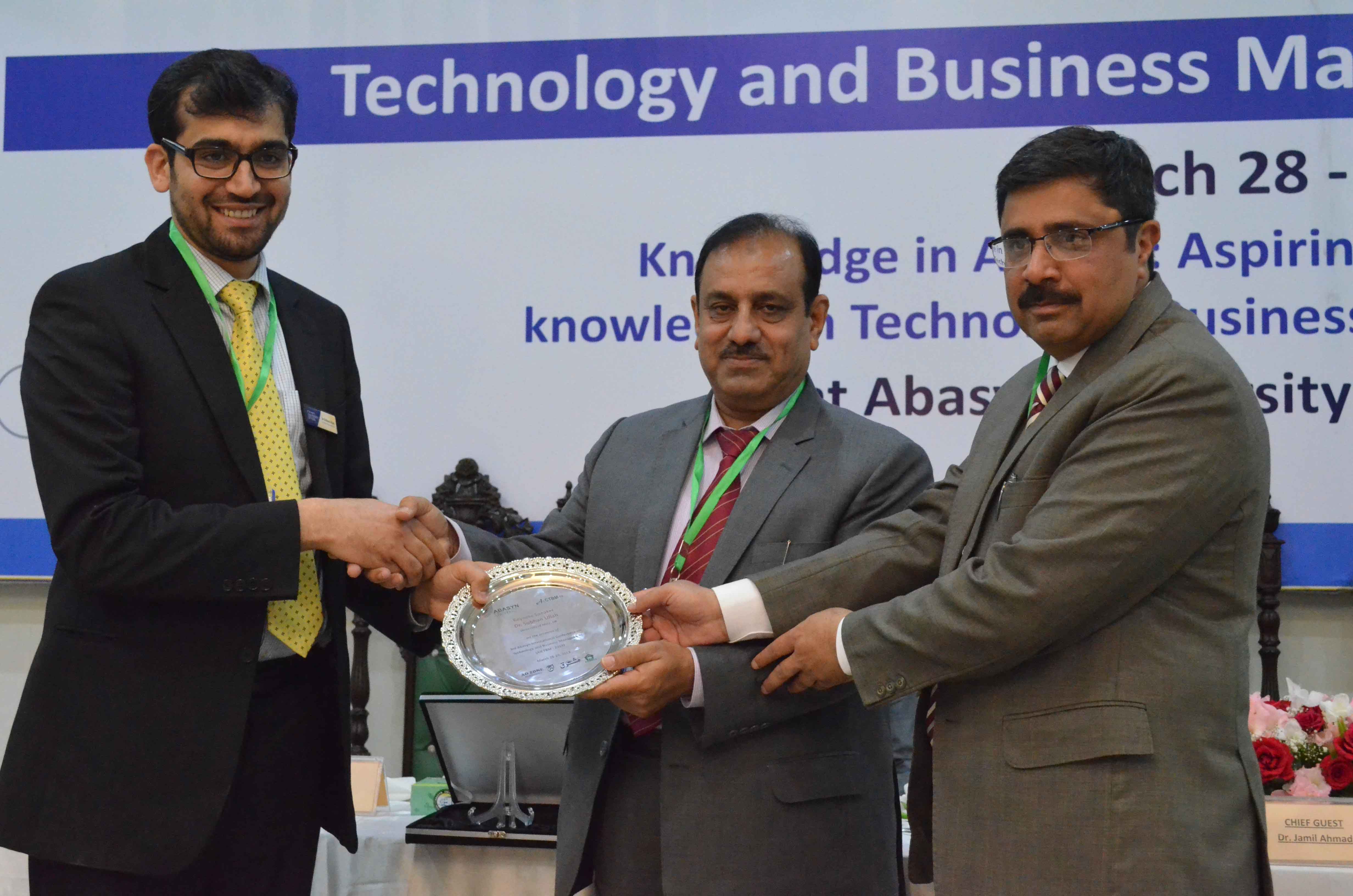 Chief guest Dr. Jamil Ahmad and Chancellor Abasyn University is presenting shield to the guest speaker Dr. Subhan Ullah (Lecturer in Accounting, The U