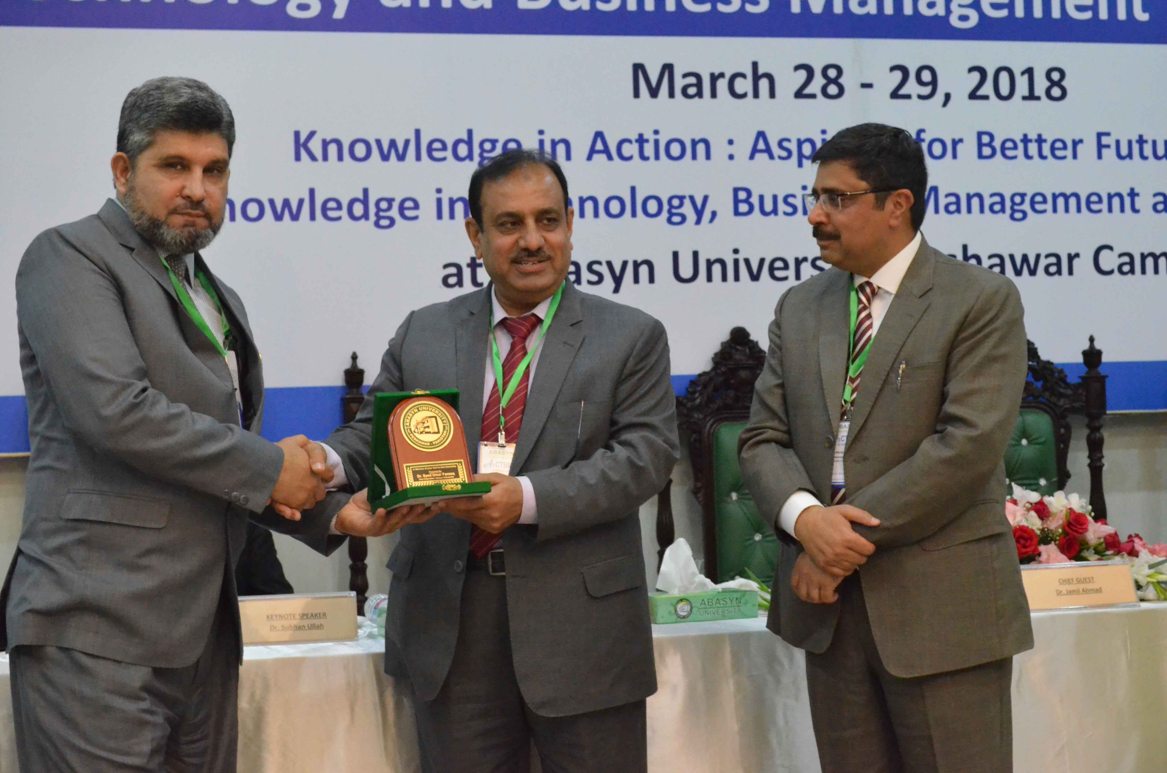 Chief guest Dr. Jamil Ahmad (VC Kohat University) is presenting shield to the VC Dr. Syed Umar Farooq (Abasyn University) 