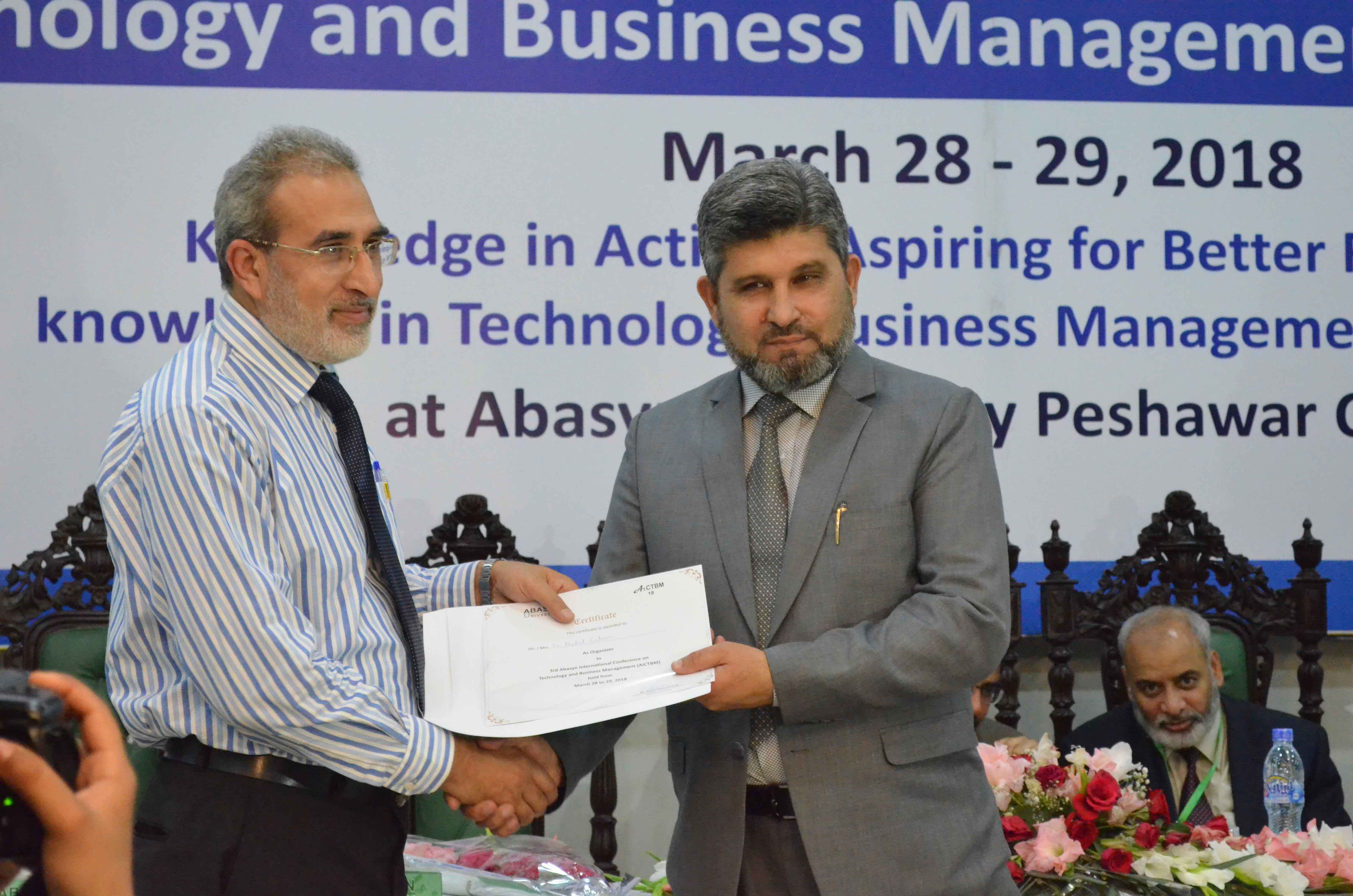 Dr. Syed Umar farooq VC (Abasyn University) is presenting shield to Dr. Abdus Salam HOD computer science (Abasyn University)