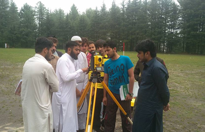Students taking readings of Total Station during Topographic Survey